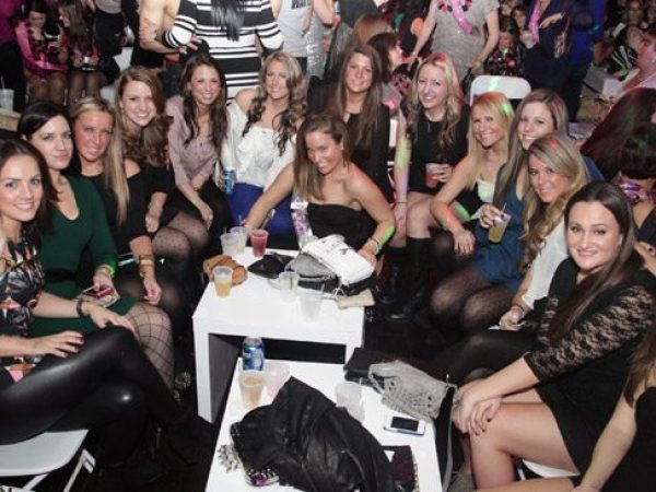 a group of people sitting in front of a crowd posing for the camera