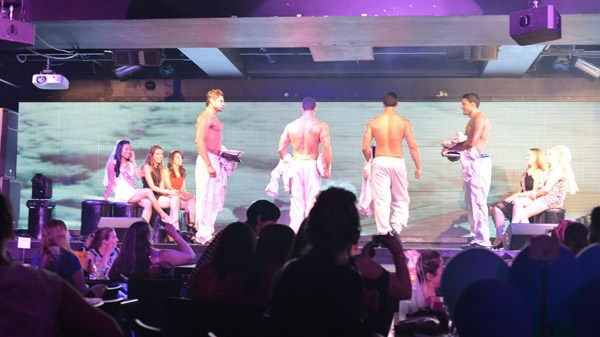 a group of people performing on stage in front of a crowd