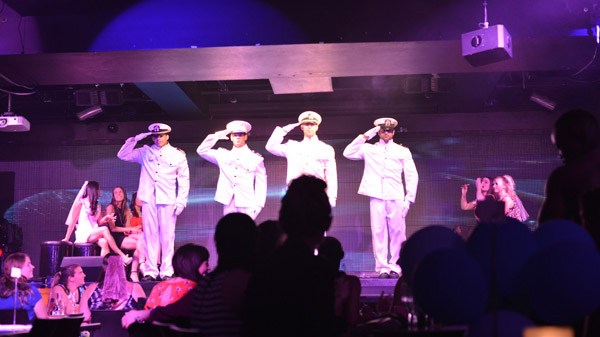 a group of people on a stage in front of a crowd