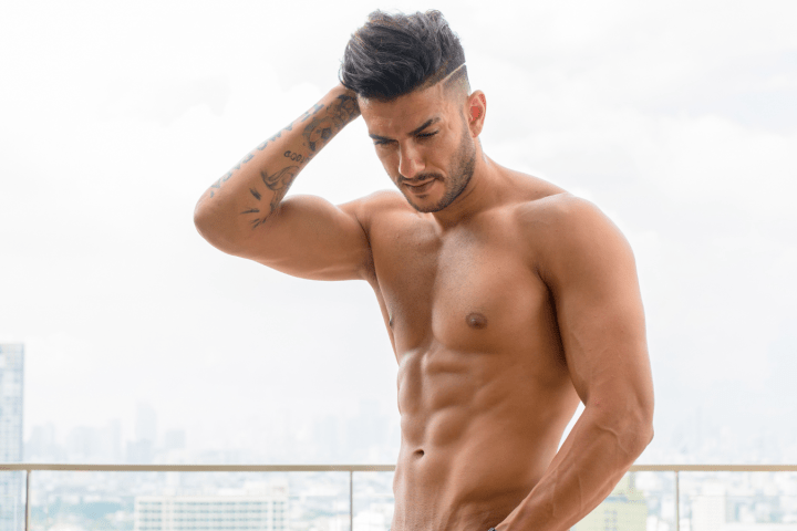 a man standing in front of a body of water