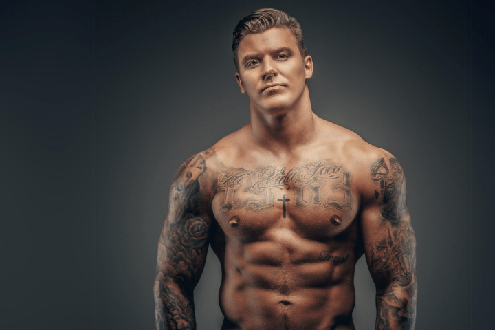 a man standing in front of a tattoo